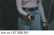 The girl plays virtual reality games in the club. Close-up controllers. Стоковое видео, видеограф Mikhail Davidovich / Фотобанк Лори