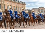 STOCKHOLM, SWEDEN - APRIL 30, 2018: Royal Guard cavalry on horses in blue uniforms. The celebration of King Carl XVI Gustaf 72 years old, at the Royal Palace in Stockholm. Редакционное фото, фотограф Сергей Комаров / Фотобанк Лори