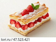A refined strawberry mille-feuille, revealing its intricate layers. Each slice boasts golden pastry, pure white cream, and vibrant red strawberries, epitomizing French pastry craftsmanship. Стоковое AI-изображение, AI-художник Nart / Фотобанк Лори