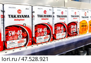 Takayama motor oil in metal canisters on the shelf at a superstore. Редакционное фото, фотограф FotograFF / Фотобанк Лори