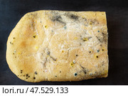 A variety of mold fungi on a loaf of bread. Mold growing on a loaf of bread indicates rotting and spoiled food in the kitchen. Expired food. Стоковое фото, фотограф Оксана Медведева / Фотобанк Лори