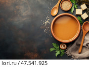 A rustic feast awaits with this earthy miso soup served in a textured clay bowl. Rich umami flavors and authentic Japanese flair create a satisfying culinary experience. Стоковое AI-изображение, AI-художник Nart / Фотобанк Лори