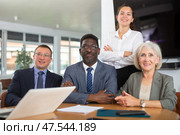Smiling business men and woman posing together sitting at the table. Стоковое фото, фотограф Яков Филимонов / Фотобанк Лори