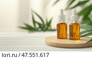 Natural herbal oils display with green leaves on wooden surface in serene indoor setting. Стоковое AI-изображение, AI-художник Сергей Толмачёв / Фотобанк Лори