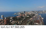 Aerial view of vladivostok, russia, showcasing the cityscape, cargo port, zolotoy rog bay, and russky bridge under a clear blue sky. Стоковое фото, фотограф Mikhail Davidovich / Фотобанк Лори