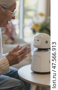 Elderly woman interacting with a robot companion at home. Стоковое AI-видео, аниматор Юрий Поздников / Фотобанк Лори