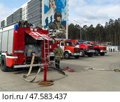 ANGARSK, IRKUTSK REGION, RUSSIA - April 08, 2025: Firefighters connect fire hose to street hydrant to extinguish fire. Red fire trucks lined up on square. Preventive training of firefighters. EMERCOM. Редакционное фото, фотограф Виктория Катьянова / Фотобанк Лори