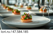 Gourmet salmon salad served on elegant plates in a modern restaurant setting. Изысканный салат из лосося подается на элегантных тарелках в современной ресторанной обстановке. Стоковое AI-изображение, AI-художник Katsiaryna Repich / Фотобанк Лори