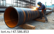Welding large steel pipes at a construction site during daylight. Сварка больших стальных труб на строительной площадке при дневном свете. Стоковое AI-изображение, AI-художник Katsiaryna Repich / Фотобанк Лори