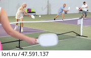 Man and woman training to play pickleball tennis on the pickleball cour. Стоковое фото, фотограф Яков Филимонов / Фотобанк Лори