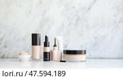 Makeup products arranged on a marble countertop highlighting beauty essentials for a flawless finish. Стоковое AI-изображение, AI-художник Сергей Толмачёв / Фотобанк Лори