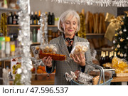 Elderly woman choosing marzipan and panellets in grocery store. Стоковое фото, фотограф Яков Филимонов / Фотобанк Лори