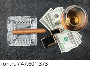 Man's lifestyle is alcohol, money, smoking. Стоковое фото, фотограф Александр Собко / Фотобанк Лори