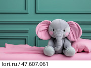 Cute gray elephant plush toy sitting on a pink blanket in a cozy room. Милая плюшевая игрушка серый слон сидит на розовом одеяле в уютной комнате. Стоковое AI-изображение, AI-художник Katsiaryna Repich / Фотобанк Лори