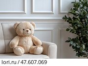 Cozy teddy bear resting on a soft sofa in a serene living room setting. Уютный плюшевый мишка сидит на мягком диване в безмятежной обстановке гостиной. Стоковое AI-изображение, AI-художник Katsiaryna Repich / Фотобанк Лори