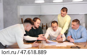 Man appearing upset as reading document, while friends gathering around, offering support and advices during friendly meeting at home kitchen. Стоковое видео, видеограф Яков Филимонов / Фотобанк Лори