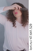 Morning starts with self-love: woman with curly hair brushes her curls and gives her scalp a relaxing massage. Стоковое видео, видеограф Svetlana Golovco / Фотобанк Лори