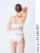 Back pain, woman with osteochondrosis and backache on gray background. Стоковое фото, фотограф Станислав Тарко / Фотобанк Лори