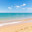 Sunny beach with a turquoise ocean in the background. Sea waves near the tropical coast on a sunny day. Cruise. Landscape of a summer sea beach with white sand and shells. Travel concept. Стоковое фото, фотограф Ирина Михайличенко / Фотобанк Лори