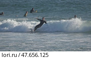 13 April 2025, Costa da Caparica - Portugal - Surfer riding waves and performing tricks in ocean. Редакционное видео, видеограф Константин Шишкин / Фотобанк Лори