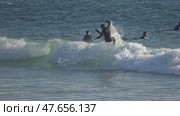13 April 2025, Costa da Caparica - Portugal - Surfer riding waves and performing tricks in the ocean. Редакционное видео, видеограф Константин Шишкин / Фотобанк Лори