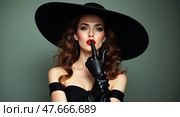 Sophisticated woman in mysterious pose with riding crop. Стоковое AI-изображение, AI-художник Андрей Бакусов / Фотобанк Лори