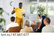 African american male teacher lecturing to students at auditorium. Стоковое фото, фотограф Яков Филимонов / Фотобанк Лори
