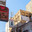 Manama, Bahrain - Jan 08 2024, panoramic view of facades of buildings with signages with inscriptions in Arabic on a narrow street, at daytime with a clear blue sky, without people, Manama, Bahrain. Редакционное фото, фотограф Сергей Богомяко / Фотобанк Лори