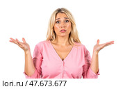 Young blonde female in pink buttoned blouse standing against white background, raising palms, questioning facial expression, unsure reaction, puzzled emotion, lost in thought, doubtful, frustrated. Стоковое AI-изображение, AI-художник Павел Муравьев / Фотобанк Лори