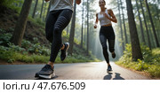 Wide and low angle shot of a happy couple running in the forest trail. Intentional motion blur. Focus is on legs. Стоковое AI-изображение, AI-художник Катерина Ковалева / Фотобанк Лори