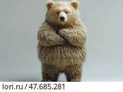 An image of a cute bear standing on its hind legs in a studio setting with a neutral background. The bear looks furry, well-groomed, and a little comically serious - its paws are crossed over its chest, as if it is thinking or watching with disbelief. The lighting is soft, emphasizing the texture of the fur. The photo is great for themes related to wildlife, humor, mascots, illustrations for children's products, or environmental projects. Стоковое AI-изображение, AI-художник Анна Кривицкая / Фотобанк Лори