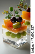 Elegant fruit jelly dessert with grapes, orange slices, and cherries. Стоковое AI-изображение, AI-художник ФотоИнтеллект / Фотобанк Лори