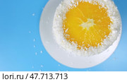 Cake with orange and coconut shavings spinning on a blue background. Стоковое видео, видеограф Mikhail Davidovich / Фотобанк Лори