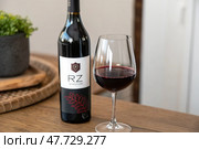 Enjoying a Glass of Red Wine Alongside a Bottle in a Cozy Setting Generative AI. Стоковое AI-изображение, AI-художник Roman Zavorotny / Фотобанк Лори