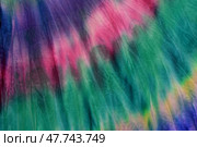 Abstract painted background. Multi-colored pattern in the shibori technique on a thin knitted fabric. Multi-color texture. batik.Textile shibori. Ткань окрашена методом узелковый батик. Стоковое фото, фотограф Ольга Солопова / Фотобанк Лори