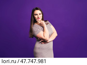 Happy plus size fashion model in casual clothes, cheerful fat woman on purple background. Стоковое фото, фотограф Станислав Тарко / Фотобанк Лори
