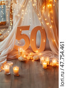 Fiftieth anniversary celebration with lighted candles and fairy lights. Стоковое AI-изображение, AI-художник Юрий Поздников / Фотобанк Лори