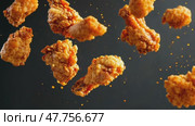 Golden Grilled chicken legs, drumsticks falling in the air, isolated on black background, food concept. Crispy fried chicken nuggets levitation. Roast chicken strips, pieces flying in the air. Dynamic. Стоковое AI-видео, аниматор Марина Демидюк / Фотобанк Лори