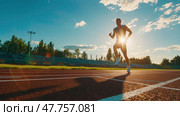 A dedicated runner sprints on a track as the sun sets, casting long shadows and illuminating the surrounding stadium. Стоковое AI-изображение, AI-художник Данила Большаков / Фотобанк Лори