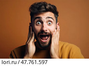 Startlingly surprised dapper young man with beard is caught off guard, his hands instinctively covering his face, against vibrant yellow background. Стоковое AI-изображение, AI-художник Данила Большаков / Фотобанк Лори