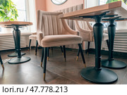 Empty beige upholstered chairs in a coffee shop in the morning. Стоковое фото, фотограф Артем Курутин / Фотобанк Лори