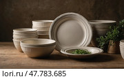 Simple and elegant pottery collection with herbs displayed on wooden table in soft light. Стоковое AI-изображение, AI-художник Сергей Толмачёв / Фотобанк Лори
