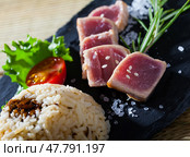 Deliciously lightly fried tuna with rice, served with greens and tomatoe. Стоковое фото, фотограф Яков Филимонов / Фотобанк Лори