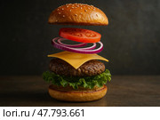 Deconstructed Cheeseburger Floating Mid-Air in Perfect Layers. Стоковое AI-изображение, AI-художник Максим Гребешков / Фотобанк Лори