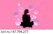 Silhouette of a person meditating surrounded by glowing orbs against a pink background at dusk. Стоковое AI-изображение, AI-художник Сергей Толмачёв / Фотобанк Лори