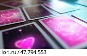 Colorful tarot cards spread out on wooden table with mystical symbols and heart designs illuminated by soft light. Стоковое AI-изображение, AI-художник Сергей Толмачёв / Фотобанк Лори