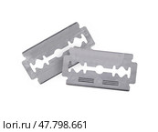 Two metal razors blade is centrally positioned isolated on a plain white background. Стоковое фото, фотограф Елена  Попкова / Фотобанк Лори