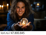 Happy woman is holding crystal ball in her hands, looking intently at it as if seeking insight or guidance. Стоковое AI-изображение, AI-художник Данила Большаков / Фотобанк Лори