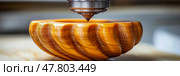 A skilled artisan operates a CNC machine to engrave detailed designs on a wooden bowl, showcasing precision craftsmanship in a workshop setting. Стоковое AI-изображение, AI-художник Данила Большаков / Фотобанк Лори