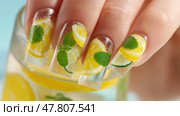 Creative nail art featuring vibrant lemon and lime designs on manicured hands. Креативный нейл-арт с яркими рисунками лимона и лайма на ухоженных руках. Стоковое AI-изображение, AI-художник Katsiaryna Repich / Фотобанк Лори